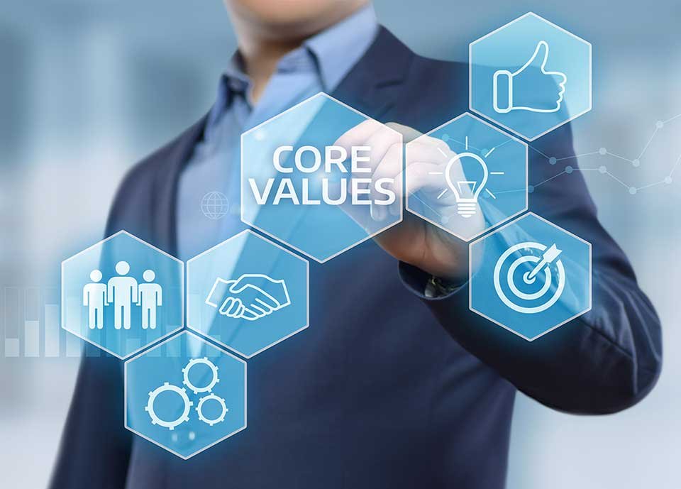 man standing behind glass with business icons and core values text