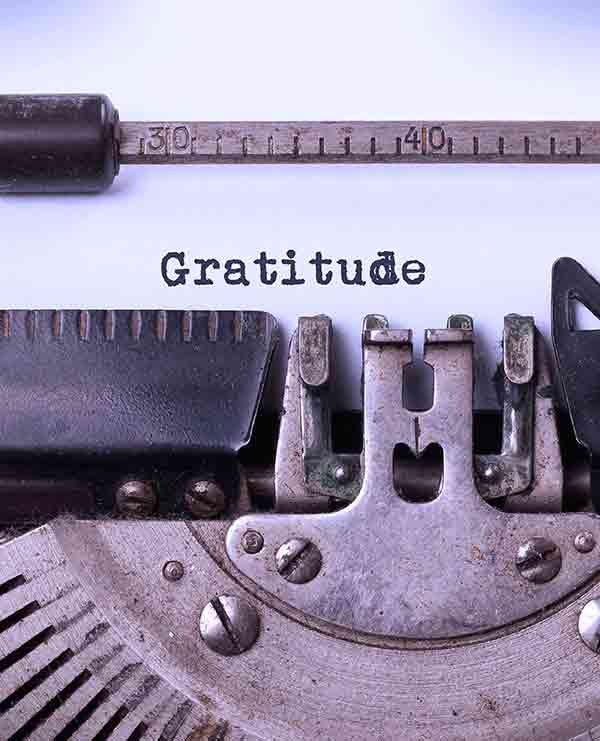 antique typewriter typing the word gratitude