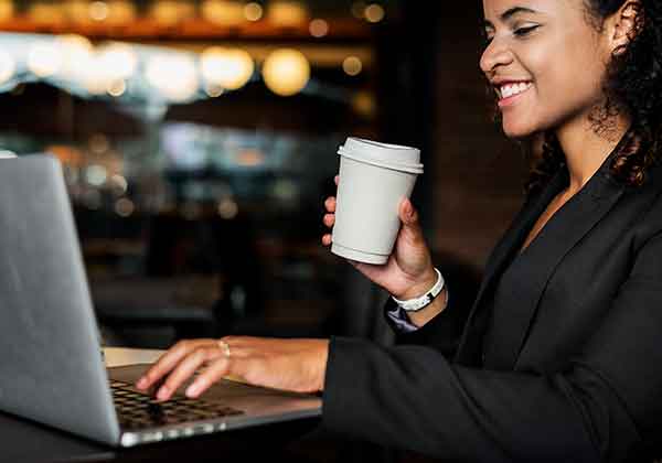 woman drining coffee and reading marketing personalization email