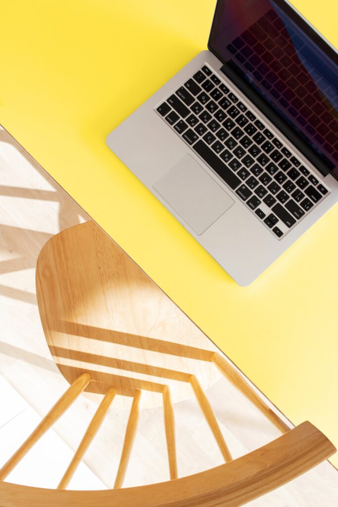 silver macbook pro on yellow table
