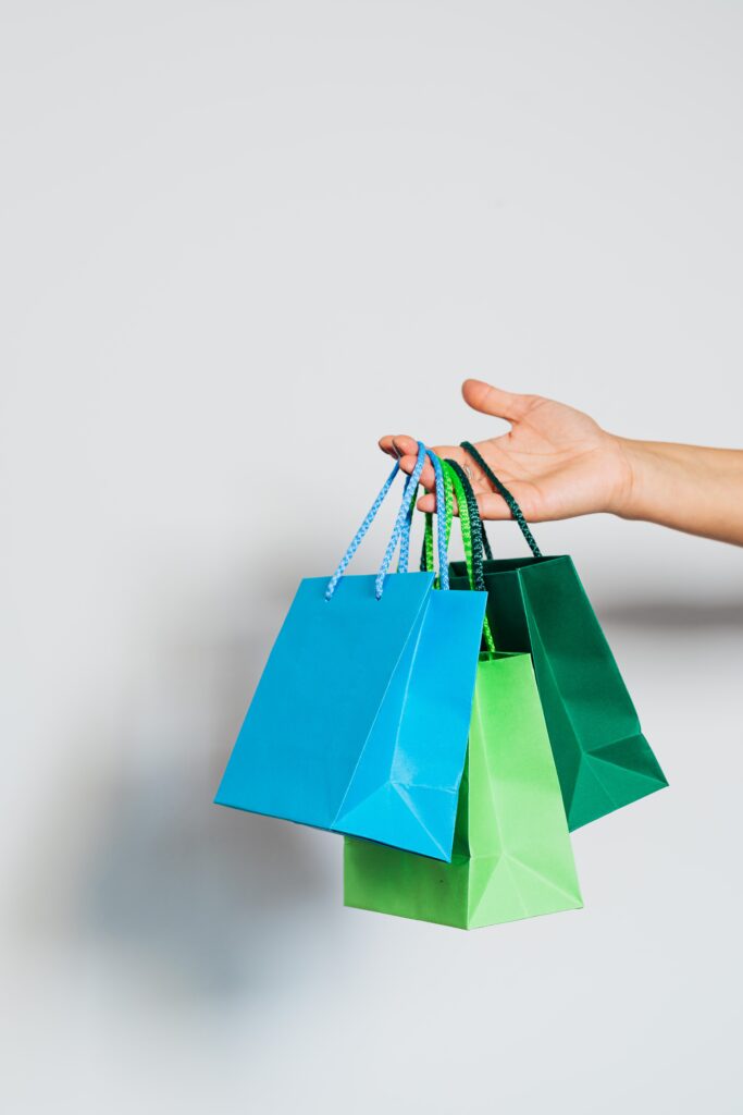 Different Colors of Paper Bags on Person's Hand