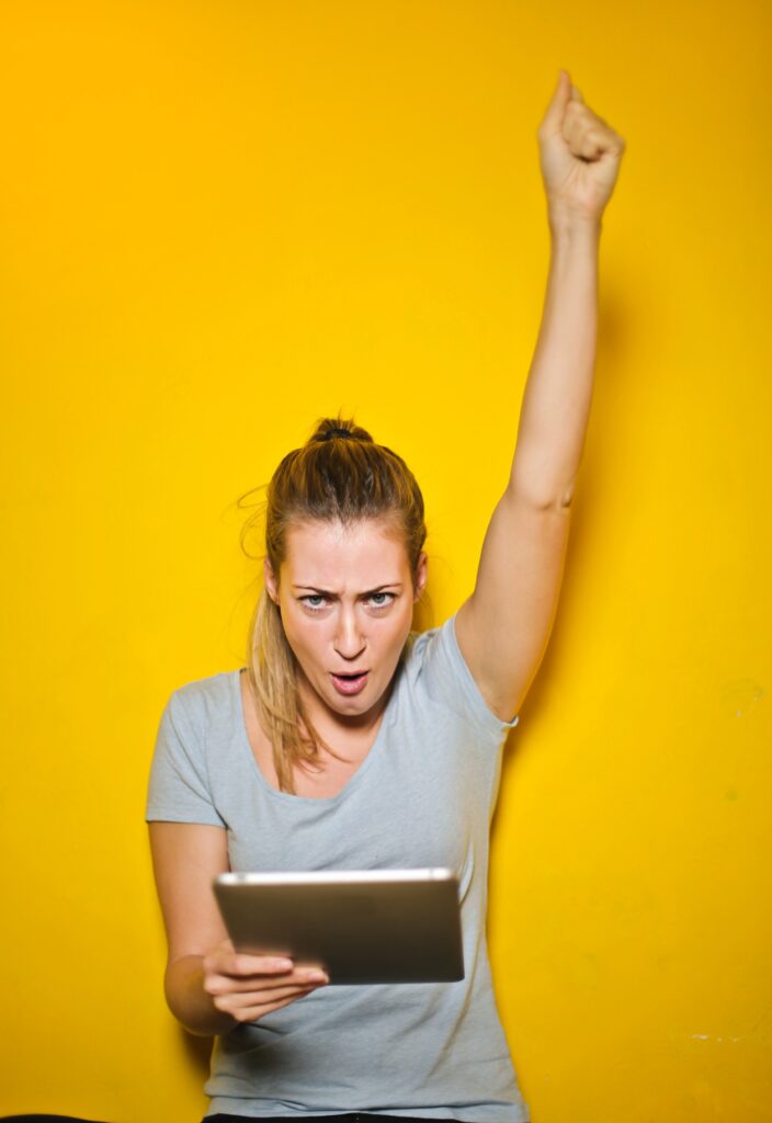 Photo of a Excited Woman Holding an Ipad