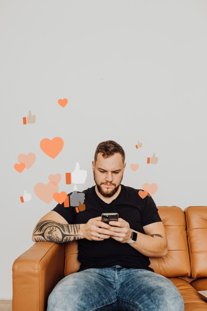 Man in Black Shirt Using Phone Leaving Like and Heart Reactions