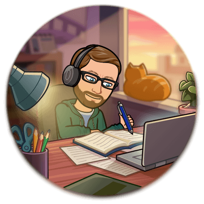 Bitmoji of bearded man wearing glasses sitting at a desk with a laptop and book